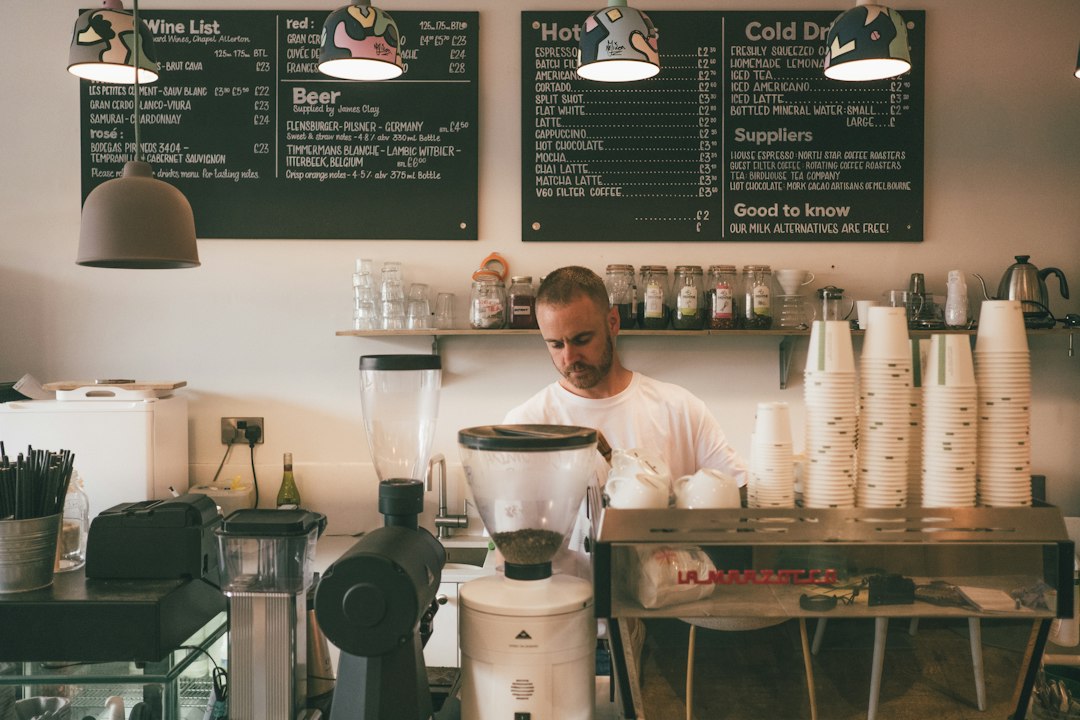 man in white dress shirt standing in front of kitchen counter - Photo by Dan Burton on Unsplash