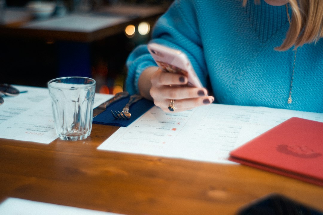 person using white smartphone - Photo by John Tuesday on Unsplash