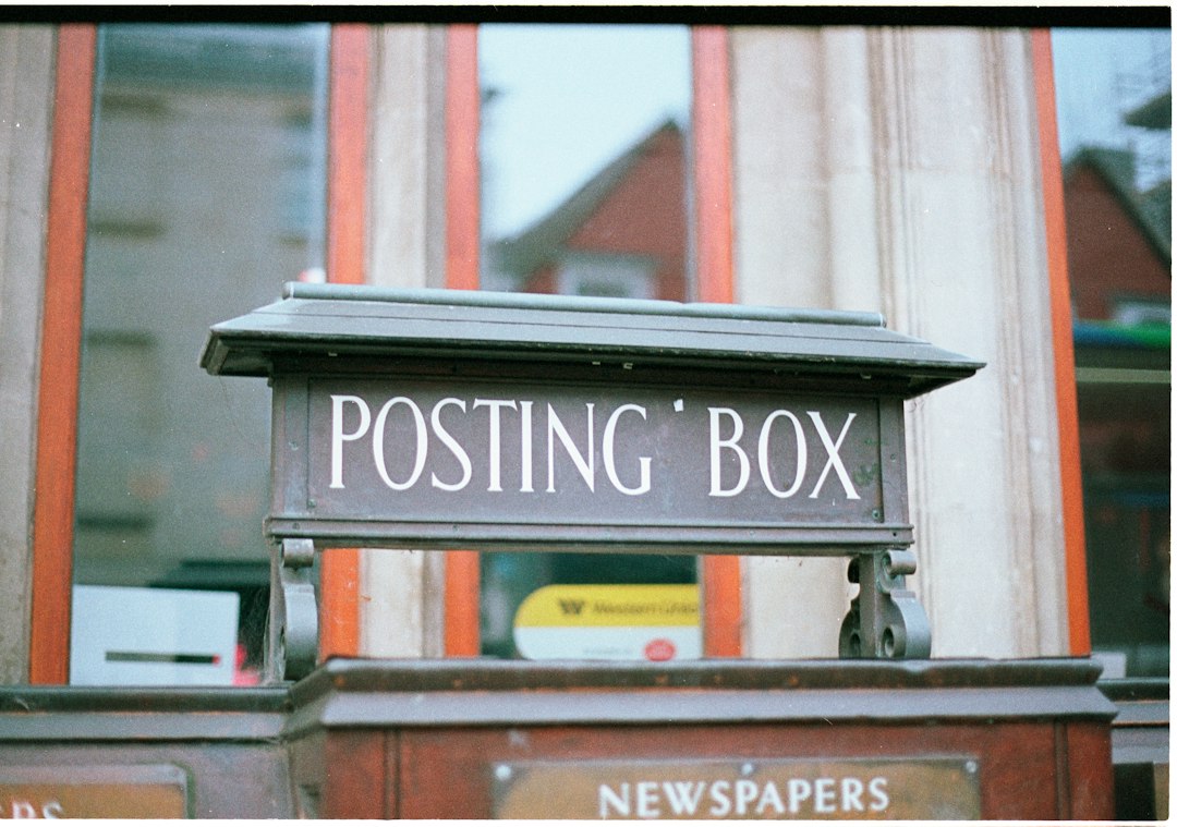 A black posting box with white lettering - Photo by Annie Spratt on Unsplash