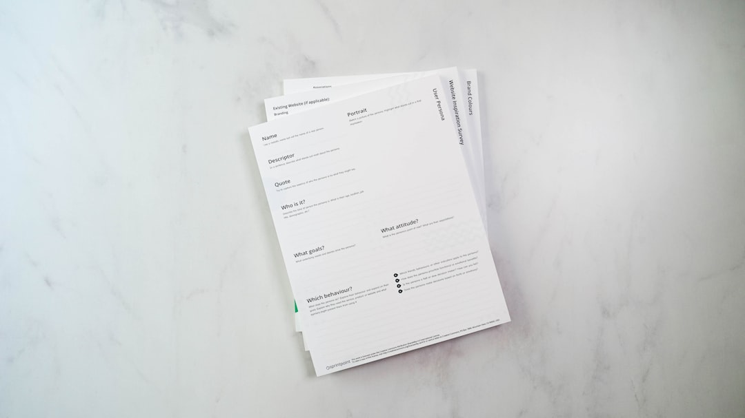 a stack of papers sitting on top of a white counter - Photo by 2H Media on Unsplash