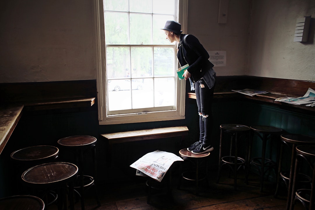 man standing near the window — Photo by Toa Heftiba on Unsplash
