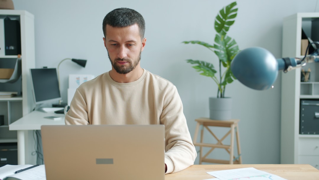 Man working on a laptop at a desk. - Photo by Vitaly Gariev on Unsplash