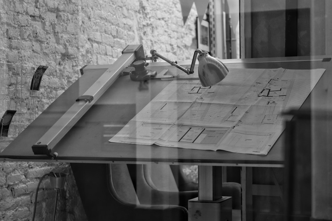 grayscale photo of chair and table — Photo by Tommy on Unsplash