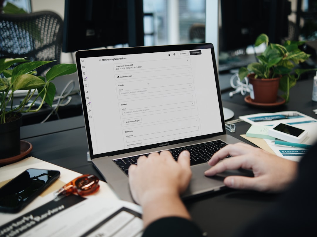 A person typing on a laptop on a desk — Photo by SumUp on Unsplash