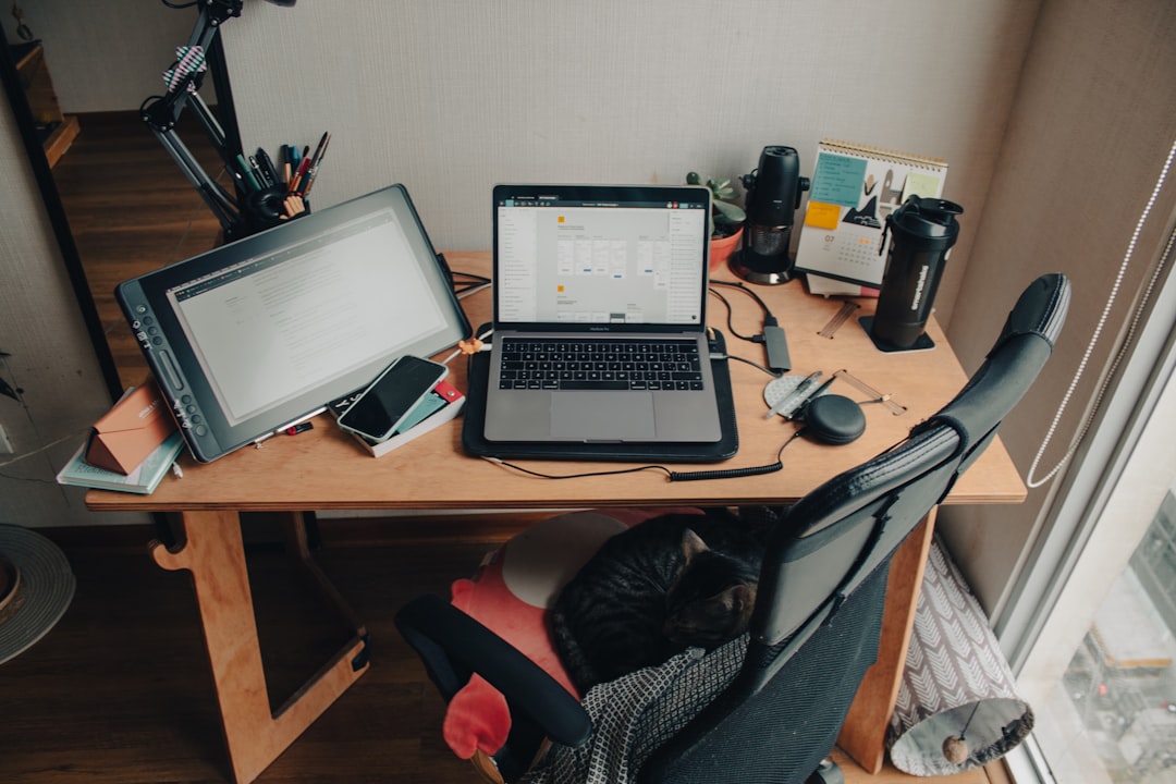 black and silver laptop computer on brown wooden desk — Photo by Elba Sindoni on Unsplash