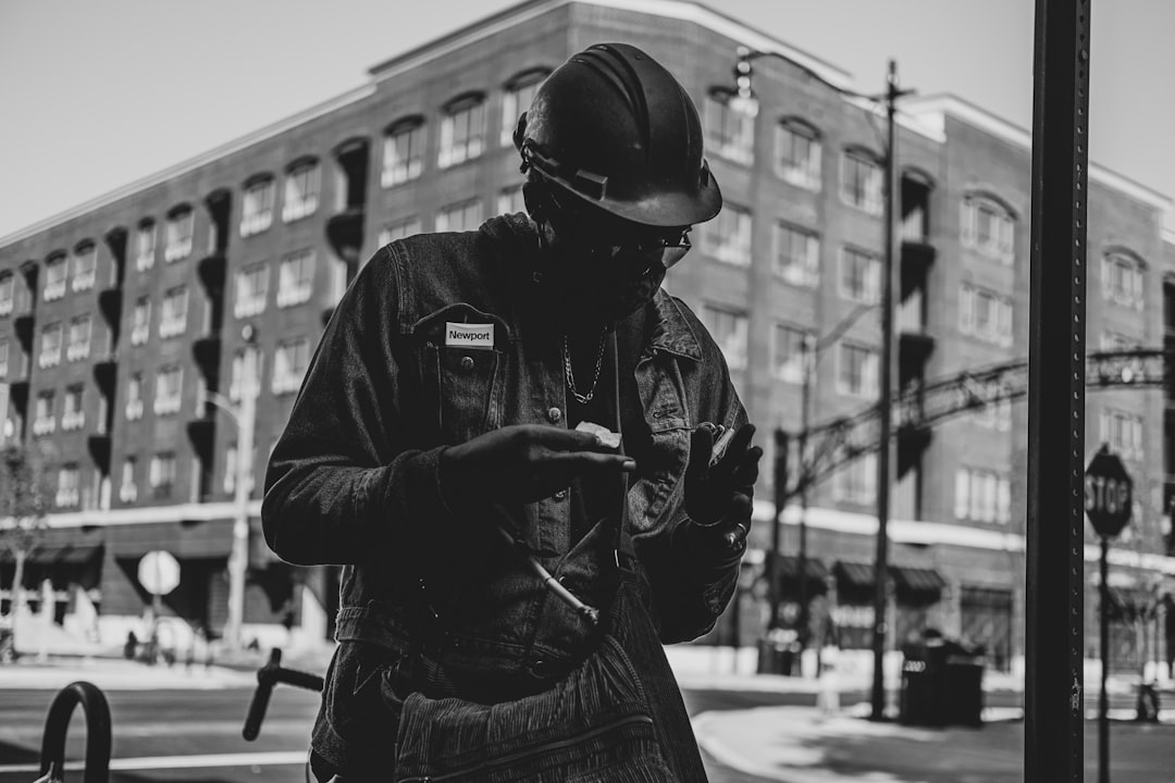 grayscale photo of man in jacket and helmet - Photo by Mike Beaumont on Unsplash