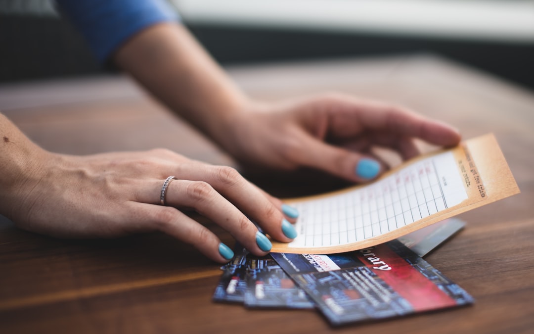 person reading card on three tickets — Photo by Anton Shuvalov on Unsplash