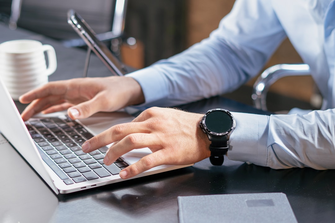 A person typing on a laptop at a desk — Photo by Mina Rad on Unsplash