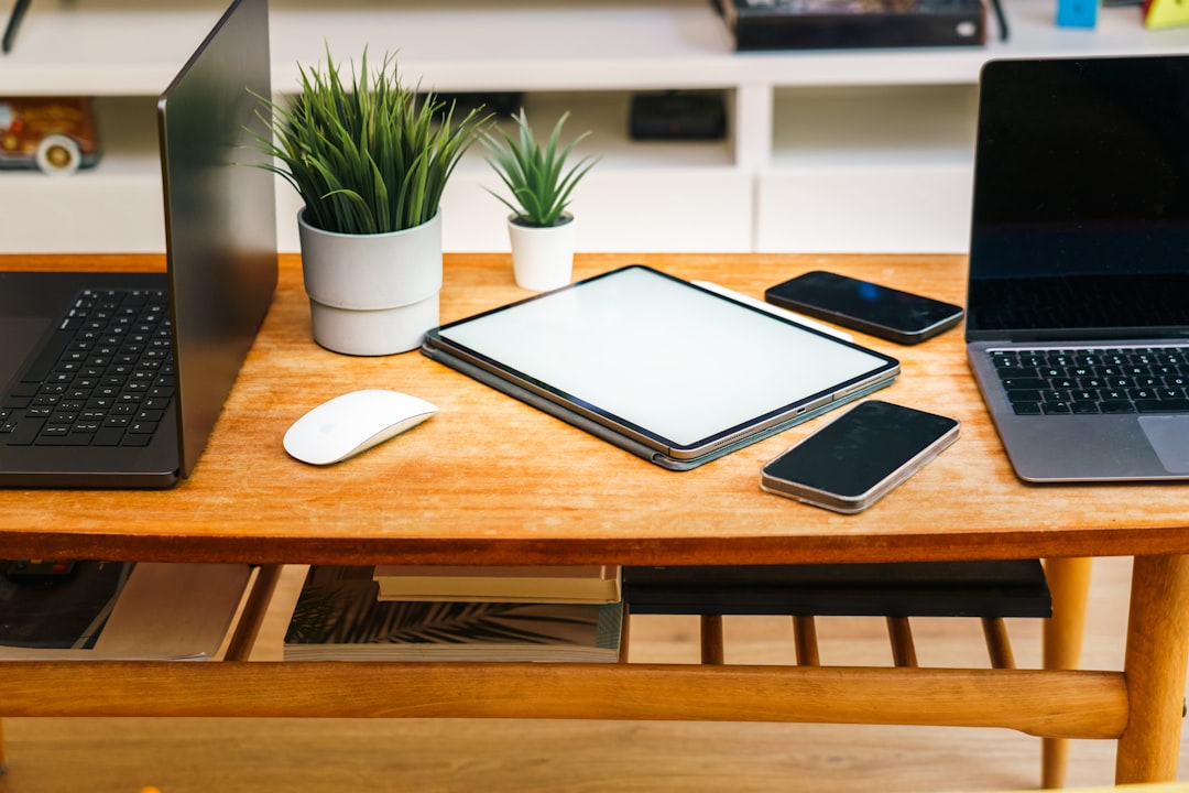 Devices like laptops, tablets, and phones are on a desk - Photo by Jakub Żerdzicki on Unsplash