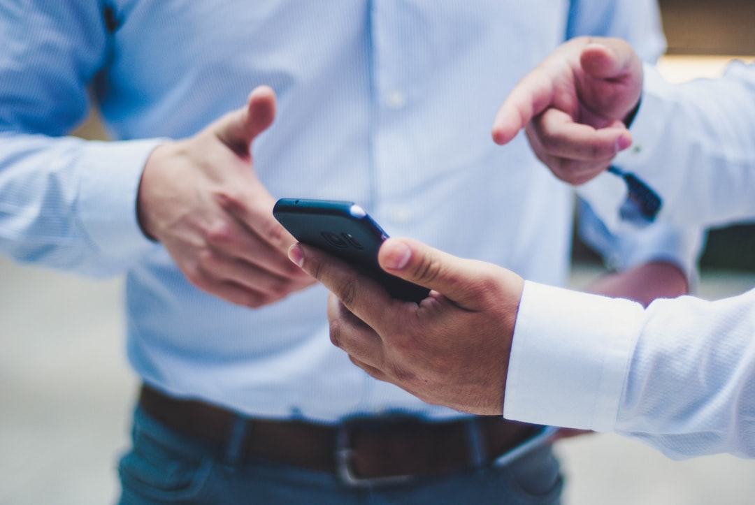person holding black smartphone - Photo by Luis Villasmil on Unsplash