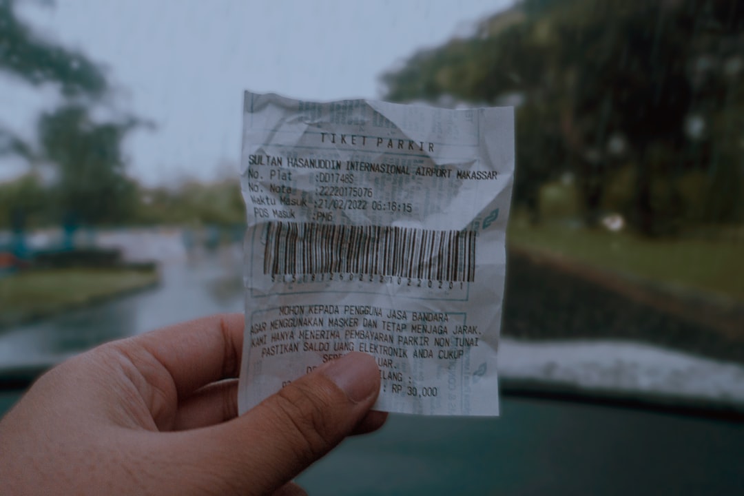 a hand holding a piece of paper with a bar code on it - Photo by Am on Unsplash