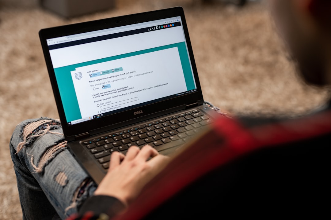 a person sitting on the floor using a laptop — Photo by ODISSEI on Unsplash