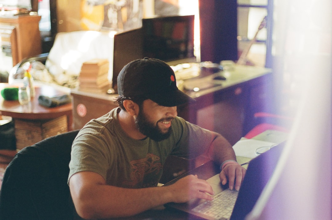 A man works at his desk indoors. — Photo by Tyler Reinert on Unsplash