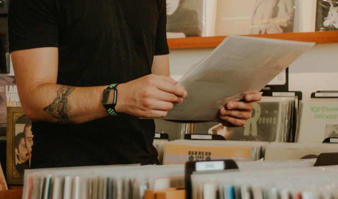 person in black long sleeve shirt holding white paper — Photo by Sebastian Cyrman on Unsplash