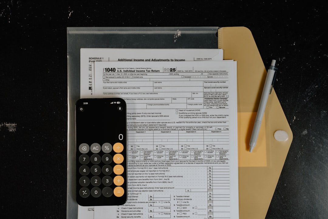 Calculator and pen on tax forms — Photo by Kelly Sikkema on Unsplash